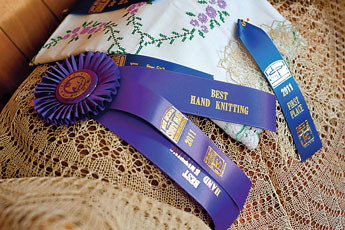 Ribbons and hand knit work are on display at Katie Bolf's home in Gallup. The 75-year-old recently won a Best of Show in the New Mexico State Fair for her hand knit work. &copy; 2011 Gallup Independent / Brian Leddy 